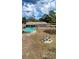 Aerial view showcases the home's above-ground pool, fire pit area, spacious backyard, and peaceful neighborhood setting at 2165 Bolger Ave, Spring Hill, FL 34609