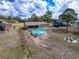 Aerial view of a home featuring a spacious backyard, a pool, and a fire pit at 2165 Bolger Ave, Spring Hill, FL 34609