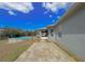 Backyard features an above-ground pool, paver patio, and easy access to the screened-in porch, ideal for outdoor living at 2165 Bolger Ave, Spring Hill, FL 34609