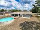 Backyard showcasing an above ground pool, wooden deck, screened in porch, and fenced yard at 2165 Bolger Ave, Spring Hill, FL 34609