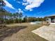 Expansive backyard with a pool, fire pit, and patio, offering ample space for recreation and outdoor enjoyment at 2165 Bolger Ave, Spring Hill, FL 34609