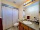 Bathroom features a tub with shower and vanity with mirror at 2165 Bolger Ave, Spring Hill, FL 34609