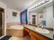 Relaxing bathroom features a soaking tub and a separate shower with glass door at 2165 Bolger Ave, Spring Hill, FL 34609