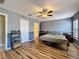 Bedroom with hardwood floors, a ceiling fan and gray walls with white trim at 2165 Bolger Ave, Spring Hill, FL 34609