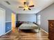 Comfortable bedroom with wood floors, light gray walls and a ceiling fan at 2165 Bolger Ave, Spring Hill, FL 34609