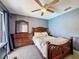 Well-lit bedroom with dresser and mirror that matches the design of the headboard at 2165 Bolger Ave, Spring Hill, FL 34609