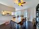 Bright dining area with hardwood floors, ceiling fan, and a view into the kitchen at 2165 Bolger Ave, Spring Hill, FL 34609