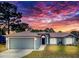Charming single story home with an attached garage and manicured lawn under a dramatic sky at 2165 Bolger Ave, Spring Hill, FL 34609
