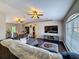 Spacious living room with hardwood floors, vaulted ceilings, and access to the dining area at 2165 Bolger Ave, Spring Hill, FL 34609