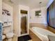 Main bathroom features an garden tub and a glass enclosed shower stall at 2165 Bolger Ave, Spring Hill, FL 34609