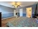 Tranquil main bedroom offers wood-look floors, neutral wall paint, a coordinating ceiling fan, and several entry points at 2165 Bolger Ave, Spring Hill, FL 34609