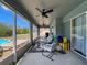 Covered patio with comfortable seating and ceiling fans, perfect for outdoor relaxation and enjoying the view of the pool at 2165 Bolger Ave, Spring Hill, FL 34609