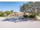 Street view of a ranch home featuring mature trees, landscaping, and three-car garage at 2224 Sand Bay Dr, Holiday, FL 34691