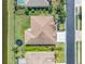Aerial view of the home, highlighting its well-manicured lawn and proximity to a serene lake at 2330 Tarragon Ln, Trinity, FL 34655