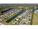 Aerial view features a lakefront community with neatly arranged homes, lush landscaping, and easy access to water views at 2330 Tarragon Ln, Trinity, FL 34655