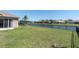 A spacious backyard features a long fenced in lawn with views of the water at 2330 Tarragon Ln, Trinity, FL 34655