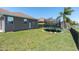 Expansive backyard featuring a trampoline and lush greenery, ideal for outdoor activities at 2330 Tarragon Ln, Trinity, FL 34655