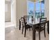 Bright dining area featuring tile flooring and a large window overlooking a peaceful pond at 2330 Tarragon Ln, Trinity, FL 34655