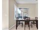 Bright dining area featuring tile flooring, a window view of the backyard, and a dark wood table at 2330 Tarragon Ln, Trinity, FL 34655