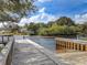 Scenic dock view by the water offering a serene and relaxing outdoor experience, surrounded by lush landscaping at 2330 Tarragon Ln, Trinity, FL 34655