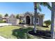 Charming single-Gathering home with a well-manicured lawn, complemented by lush landscaping and mature palm trees at 2330 Tarragon Ln, Trinity, FL 34655