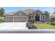 Attractive home featuring a manicured lawn, mature landscaping, and a convenient three-car garage at 2330 Tarragon Ln, Trinity, FL 34655