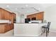 Well-lit kitchen with wooden cabinets, stainless steel appliances, and bar seating, perfect for casual dining and entertaining at 2330 Tarragon Ln, Trinity, FL 34655