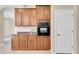 Kitchen area with ample wooden cabinets and black oven, plus lots of counter space at 2330 Tarragon Ln, Trinity, FL 34655