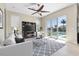 Bright living room featuring modern furniture, large windows, ceiling fan and access to the outdoor pool area at 2330 Tarragon Ln, Trinity, FL 34655