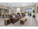 Open-concept living room and dining space with hardwood floors and a view of the outdoor patio at 2330 Tarragon Ln, Trinity, FL 34655