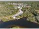 Scenic aerial view of boat ramp access to community waterway surrounded by lush trees and nearby neighborhood homes at 2330 Tarragon Ln, Trinity, FL 34655