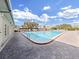 View of the outdoor pool with safety rail, next to building with a covered walkway at 2400 Franciscan Dr # 8, Clearwater, FL 33763