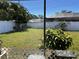 View of the backyard from the enclosed lanai, showcasing plants and lawn at 2630 63Rd S Ave, St Petersburg, FL 33712