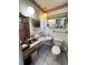 Bright bathroom features a pink-tiled shower, large mirror, and unique light fixtures at 2630 63Rd S Ave, St Petersburg, FL 33712