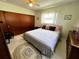 Comfortable bedroom with a plush bed, wood closet, and neutral decor at 2630 63Rd S Ave, St Petersburg, FL 33712