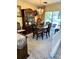 Dining room with elegant chandelier, wood table, and sliding doors leading to a patio at 2630 63Rd S Ave, St Petersburg, FL 33712