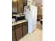 Bright kitchen featuring wood cabinets, white appliances, and tile flooring at 2630 63Rd S Ave, St Petersburg, FL 33712