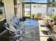 The enclosed lanai is furnished with a table, chairs, and other decorative items at 2630 63Rd S Ave, St Petersburg, FL 33712