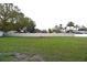 A large, open backyard with a white vinyl fence at 29341 Rhodin Pl, Wesley Chapel, FL 33545