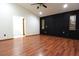 A bedroom features wood-style flooring and a dark paneled accent wall at 29341 Rhodin Pl, Wesley Chapel, FL 33545