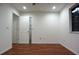A bedroom with laminate flooring and an open closet at 29341 Rhodin Pl, Wesley Chapel, FL 33545