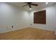 This bedroom features wood-style floors, base molding and a large window at 29341 Rhodin Pl, Wesley Chapel, FL 33545