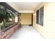 Spacious covered front porch with brick planters and a view of the neighborhood surroundings at 29341 Rhodin Pl, Wesley Chapel, FL 33545