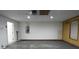 Attached garage with a side door, concrete flooring, electrical panel and lighting at 29341 Rhodin Pl, Wesley Chapel, FL 33545