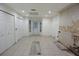 Spacious kitchen with tiled flooring, bright lighting, and a door leading to the backyard at 29341 Rhodin Pl, Wesley Chapel, FL 33545