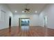 Spacious living room with hardwood floors, high ceilings, and a sliding glass door providing access to the outdoors at 29341 Rhodin Pl, Wesley Chapel, FL 33545