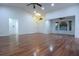 Bright, expansive living room with hardwood floors, high ceilings, and large windows for ample natural light at 29341 Rhodin Pl, Wesley Chapel, FL 33545