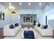 Elegant living room with neutral tones, stylish sofas, and an open layout that leads to the dining area at 29341 Rhodin Pl, Wesley Chapel, FL 33545