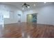 Open living room with hardwood floors, high ceilings, and a sliding glass door offering ample natural light at 29341 Rhodin Pl, Wesley Chapel, FL 33545