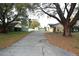 Features an exterior of the home with an expansive driveway, yard, and shed on the property at 29341 Rhodin Pl, Wesley Chapel, FL 33545